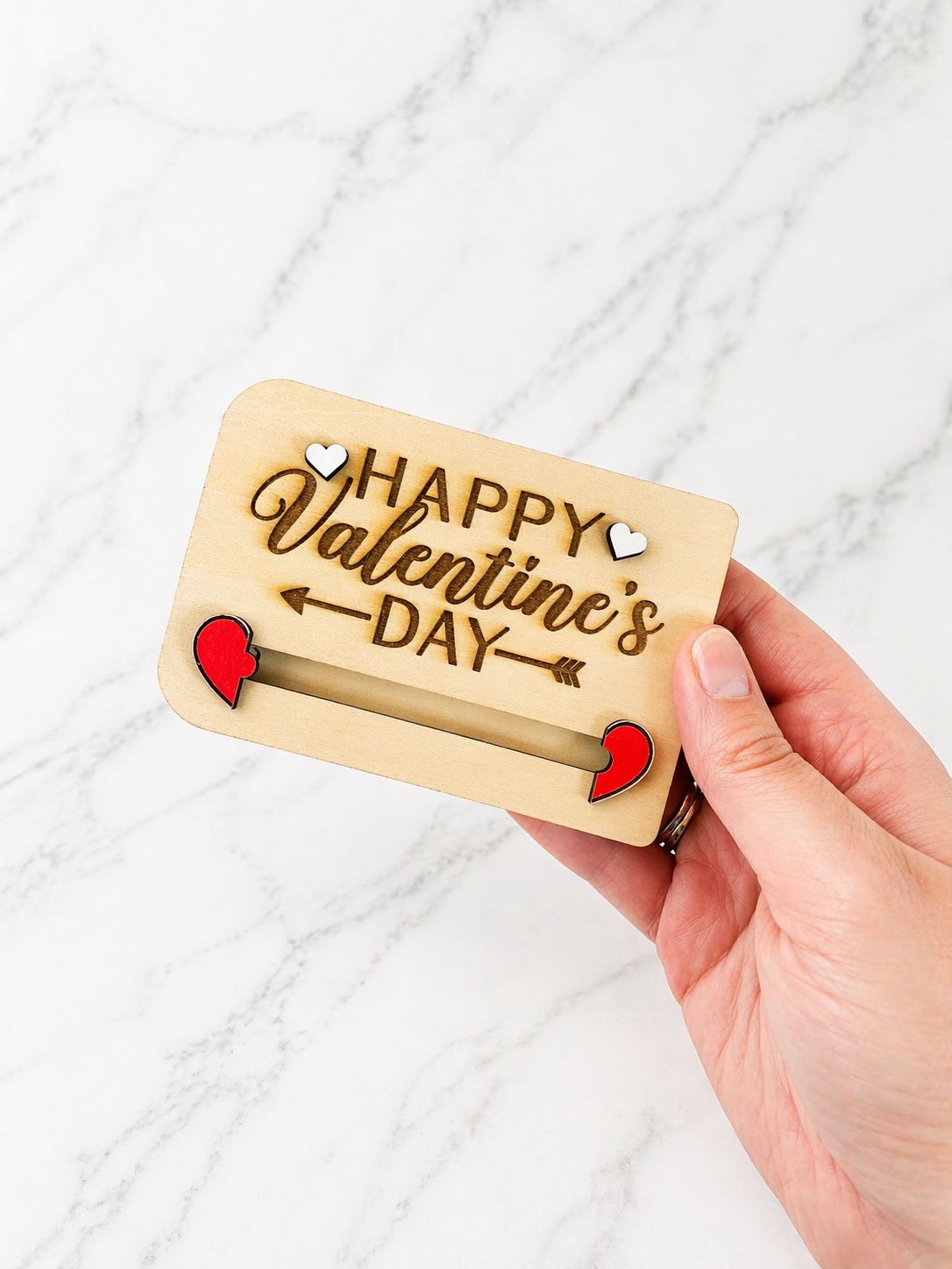 Personalised wooden Valentine’s Day gift card holder held in hand with engraved romantic design