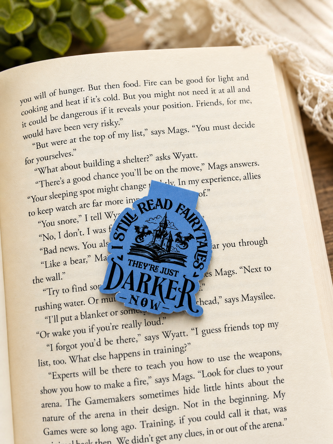 Magnetic bookmark placed on open book page in aesthetic reading setup