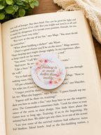 Floral magnetic bookmark with romantic quote resting on an open book in a cosy reading setting with warm tones, styled for book lovers and aesthetic gifts