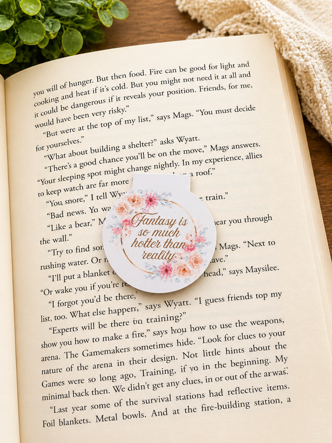 Floral magnetic bookmark with romantic quote resting on an open book in a cosy reading setting with warm tones, styled for book lovers and aesthetic gifts