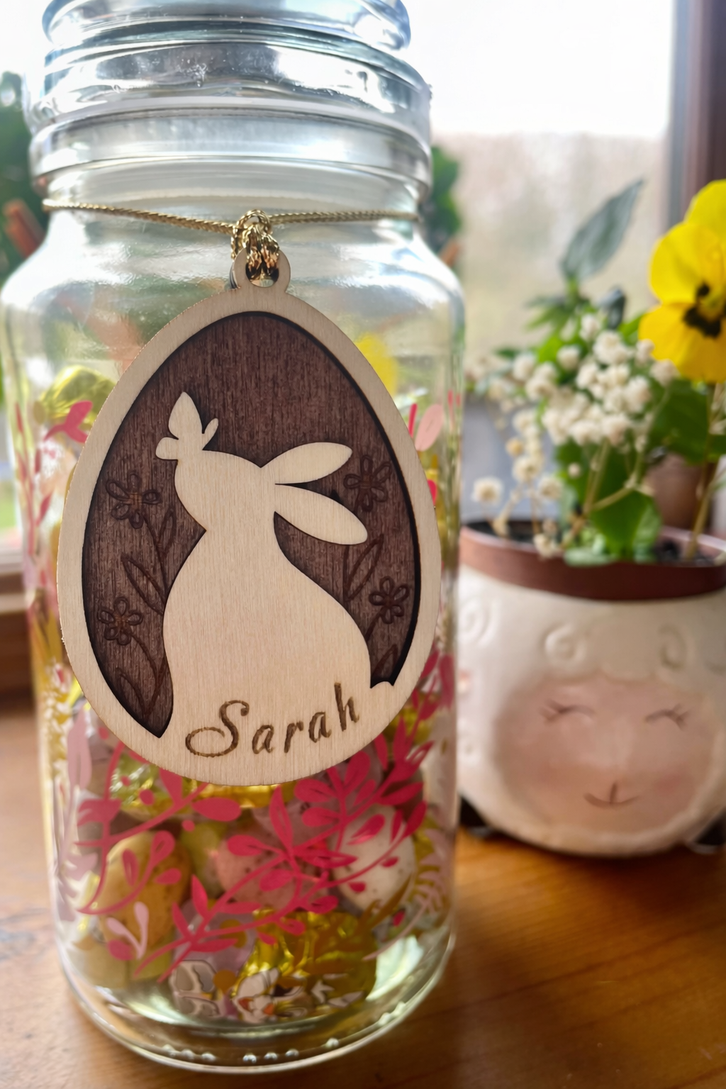 Glass jar with the dark oak stained bunny tag on it.