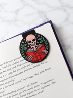 Skeleton magnetic bookmark clipped onto a book page showing how it securely holds place while reading