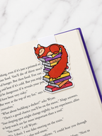 Sleeping squirrel magnetic bookmark clipped onto a book page showing use as a page holder