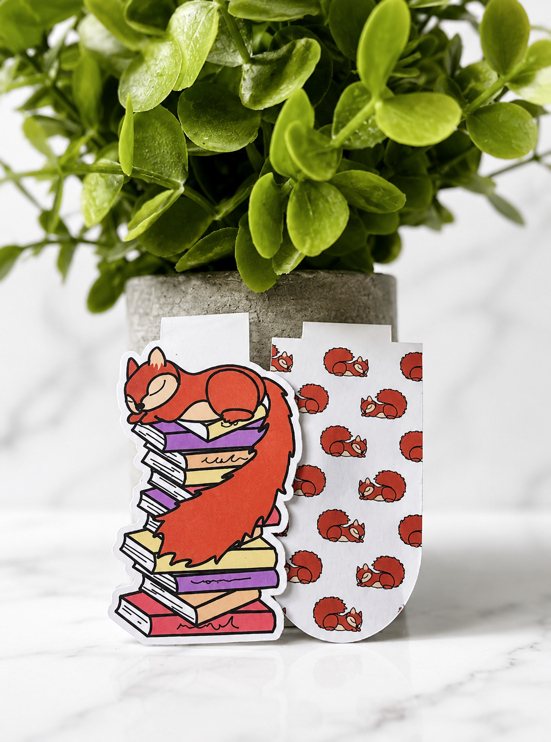 Two magnetic bookmarks featuring a sleeping squirrel character and matching pattern design displayed together