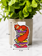 Magnetic bookmark featuring a sleeping squirrel on a stack of books with measurements 7 cm by 4 cm