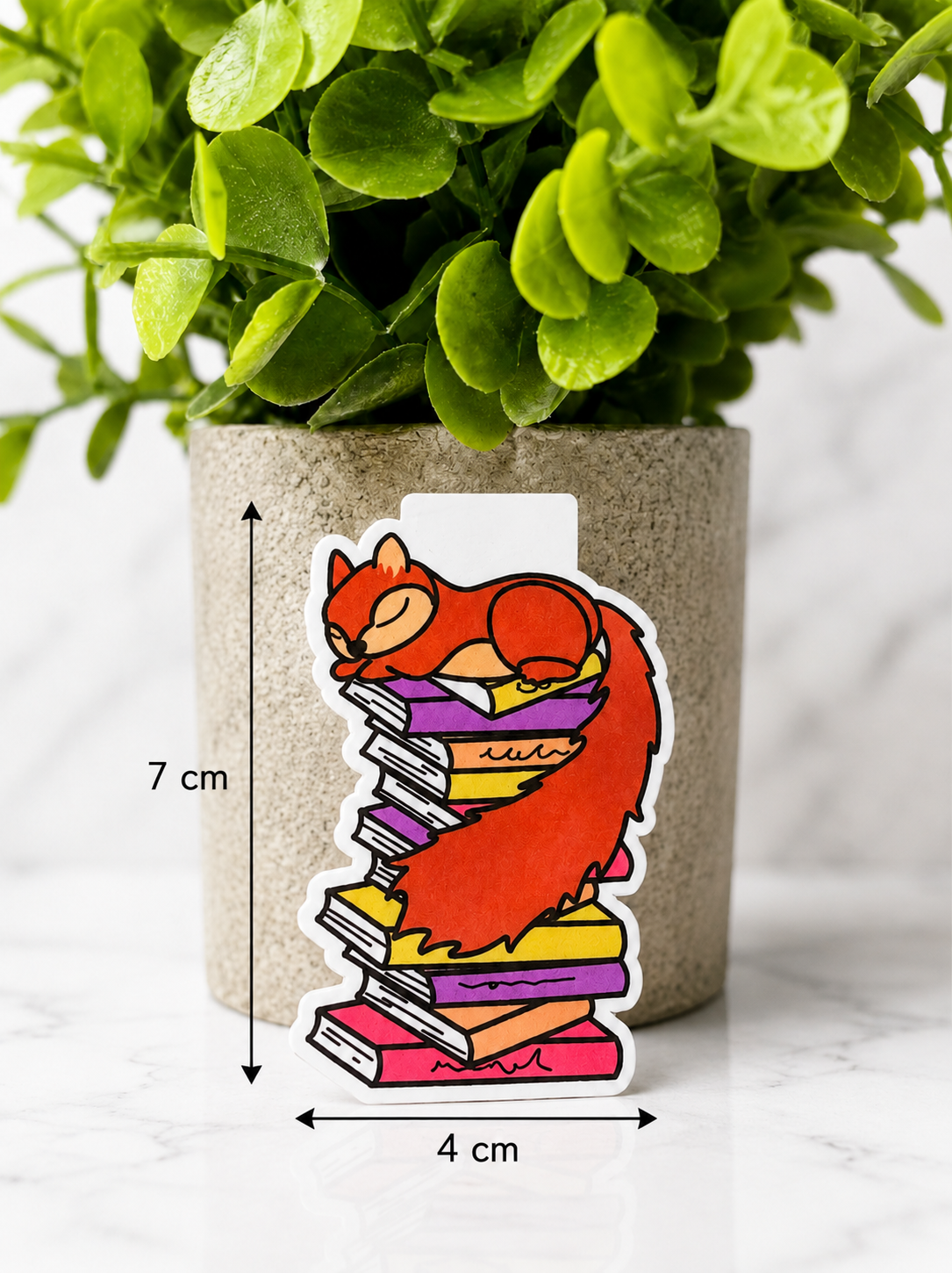 Magnetic bookmark featuring a sleeping squirrel on a stack of books with measurements 7 cm by 4 cm