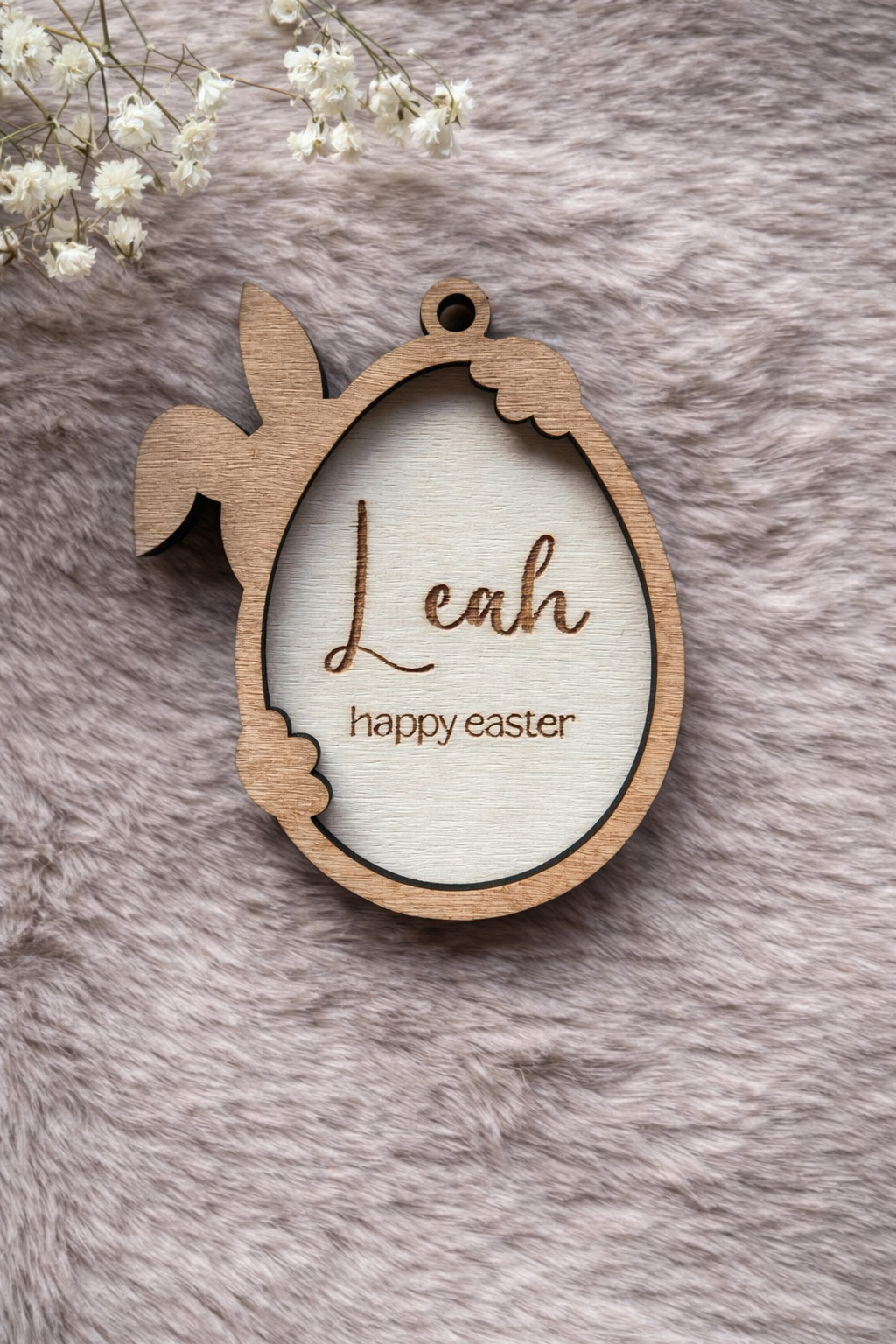 Wooden Easter tag with a bunny holding an egg. the outline is stained teak. Written inside the egg are 'Leah' and 'Happy Easter'.