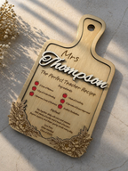 Wooden teacher appreciation plaque engraved with recipe style message and personalised name on marble surface