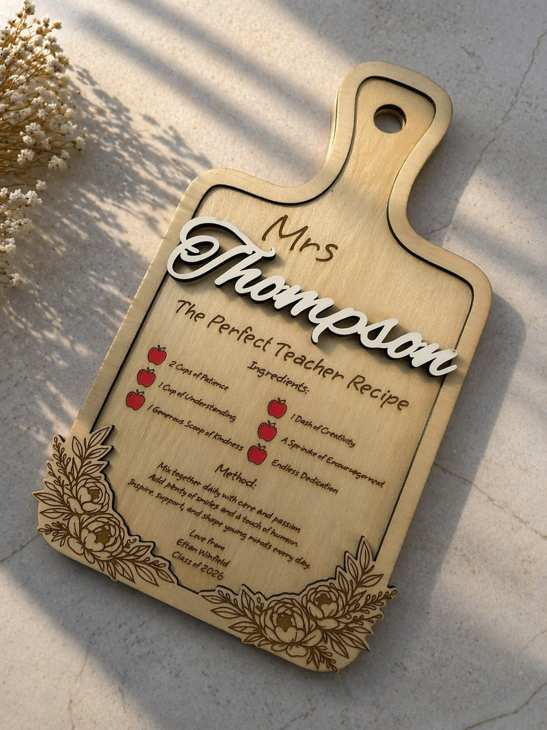 Wooden teacher appreciation plaque engraved with recipe style message and personalised name on marble surface