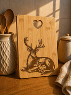 Bamboo chopping board with deer and fawn engraving styled in warm kitchen setting with utensils and natural light